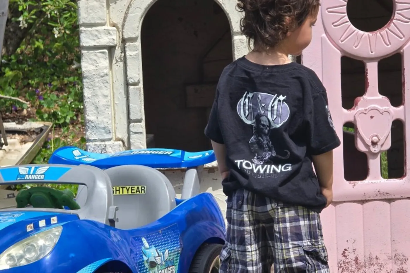 Young child in a C&C Towing shirt playing in the backyard — the next generation of C&C Inc