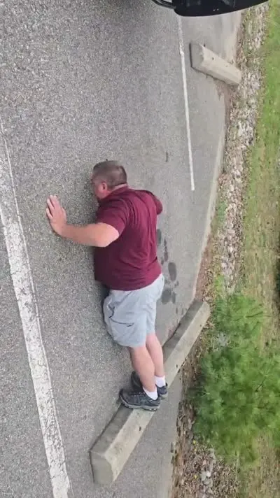 Customer doing 20 push-ups in a Roscommon parking lot to earn $20 off a C&C Inc tow